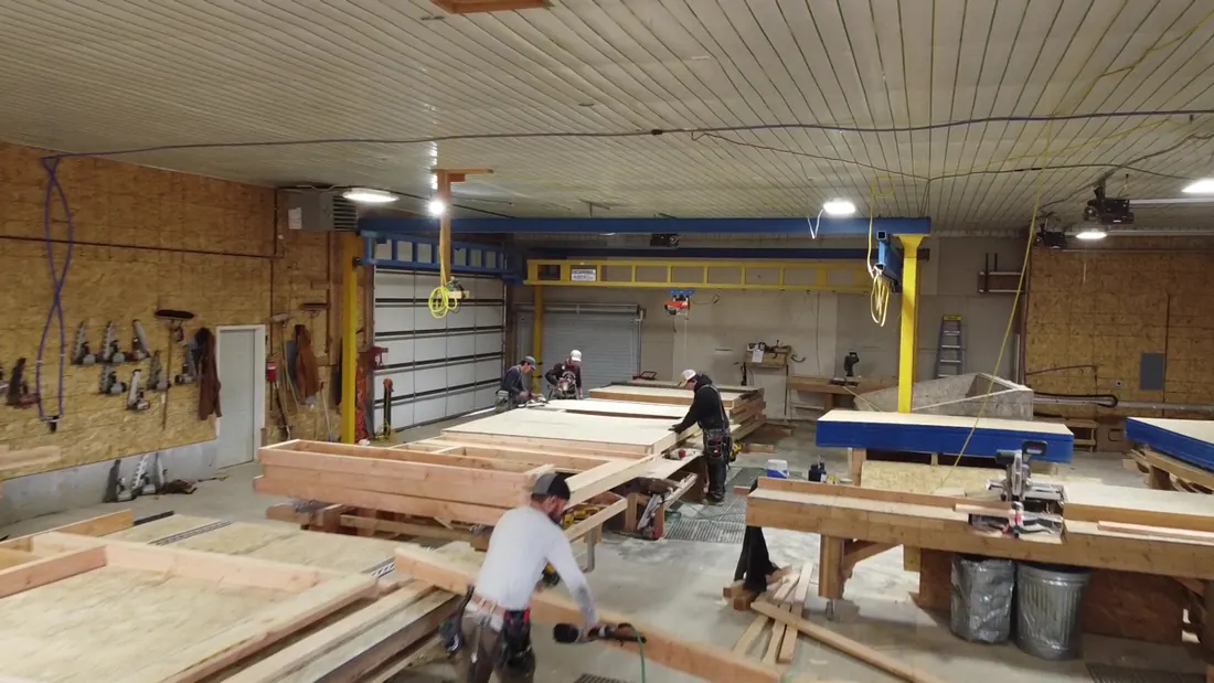 Workers assembling wall panel frames